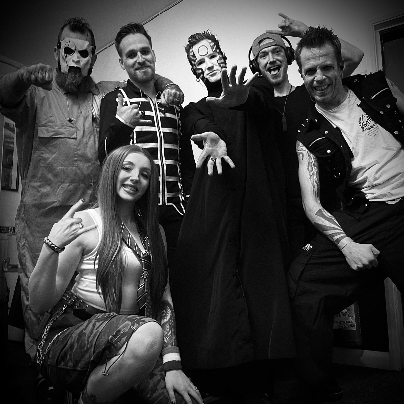Nostalgia band portrait — Dan, Olly, Matt, Tom, Joe and Chloe in full stage costume, backstage at Bush Hall, February 2026